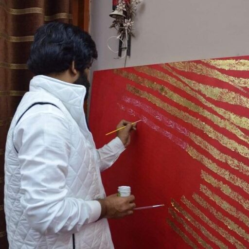 Alfirdous, Arabic & English calligrapher in Dubai, creating large red Arabic calligraphy on fabric in a bold and elegant artistic style.